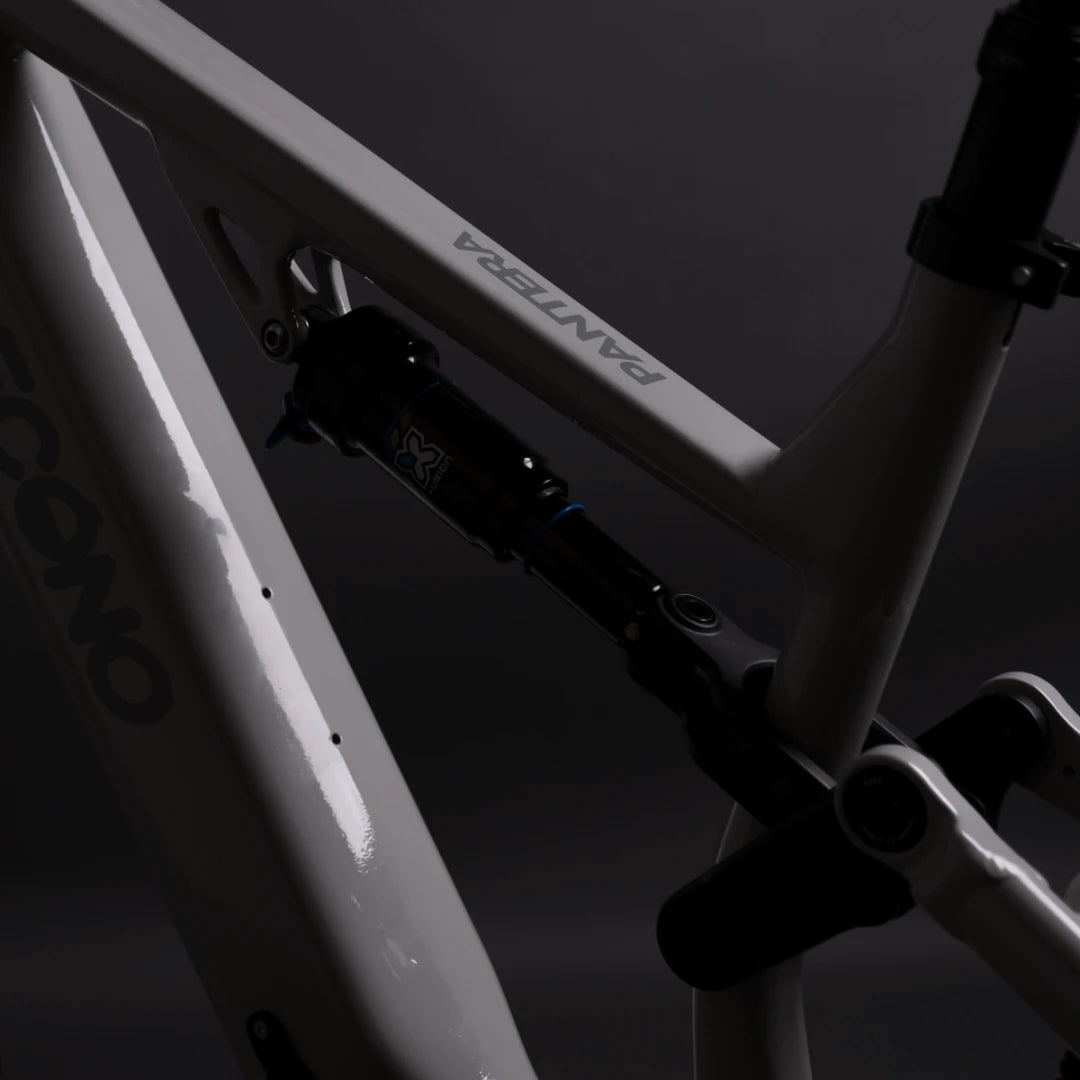 Mountain Electric Bike Econo Pantera C8 140, sleek frame detail, featuring a shock absorber and glossy finish.