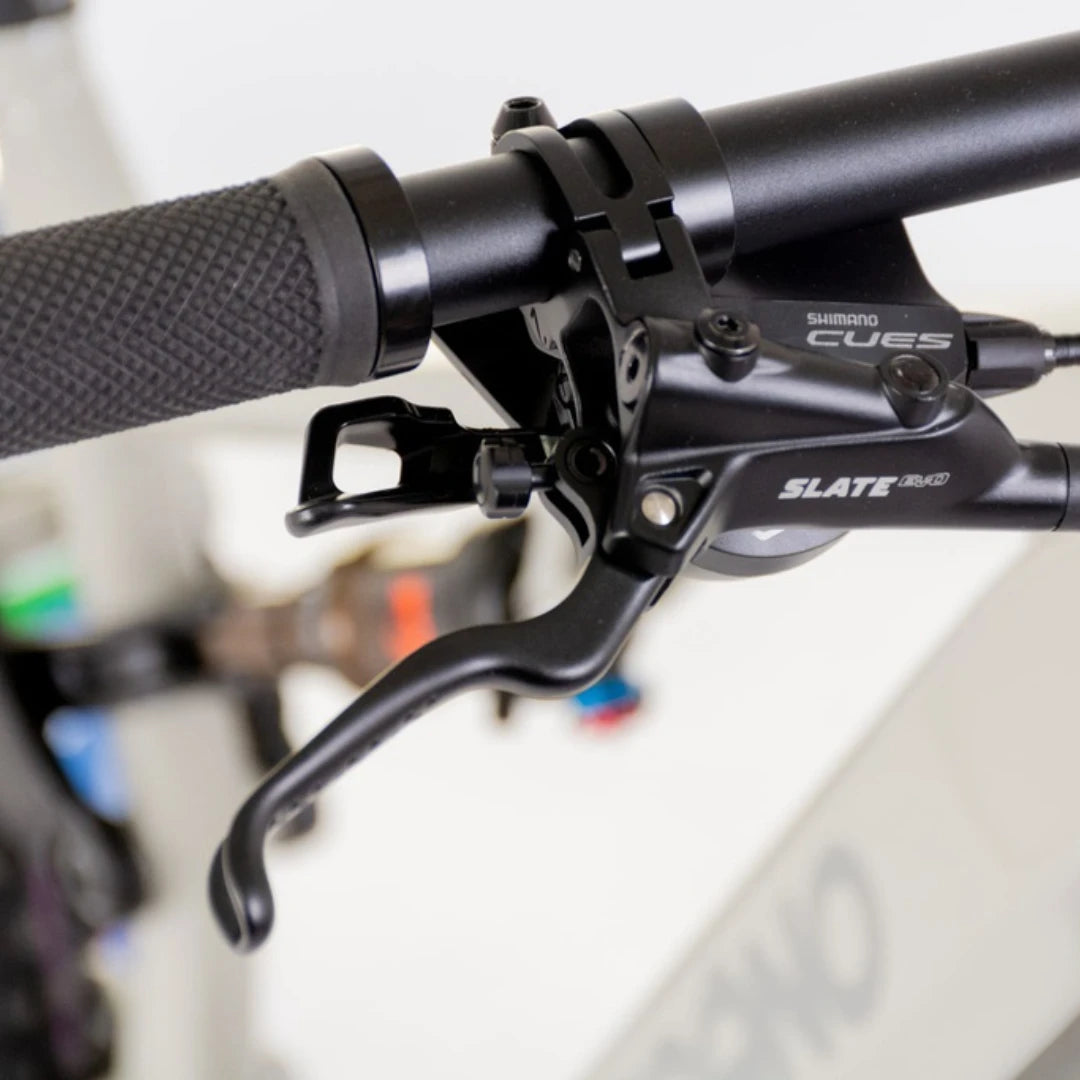 Mountain Electric Bike Econo Pantera C9 160, close-up of Shimano brake lever on handlebars, textured grip.
