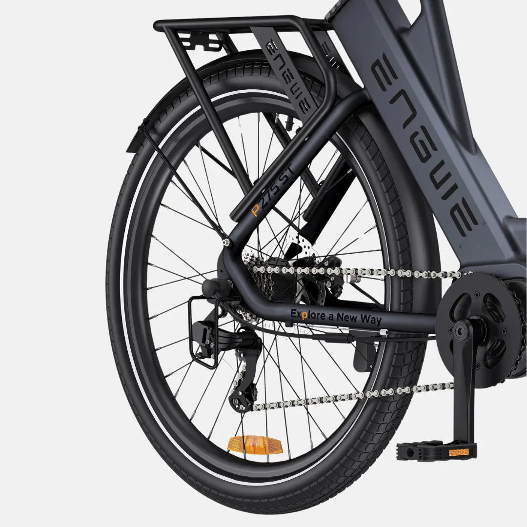 Na sliki je električno kolo znamke Engwe, model P275 ST. Vidna je zadnja stran kolesa, vključno z okvirjem, verigo, menjalnikom in pedalom. Kolo ima robustno konstrukcijo in je opremljeno s širokimi pnevmatikami ter nosilcem za dodatno opremo. Na okvirju je napis "Explore a New Way", kar nakazuje na namen raziskovanja in aktivnega preživljanja prostega časa.