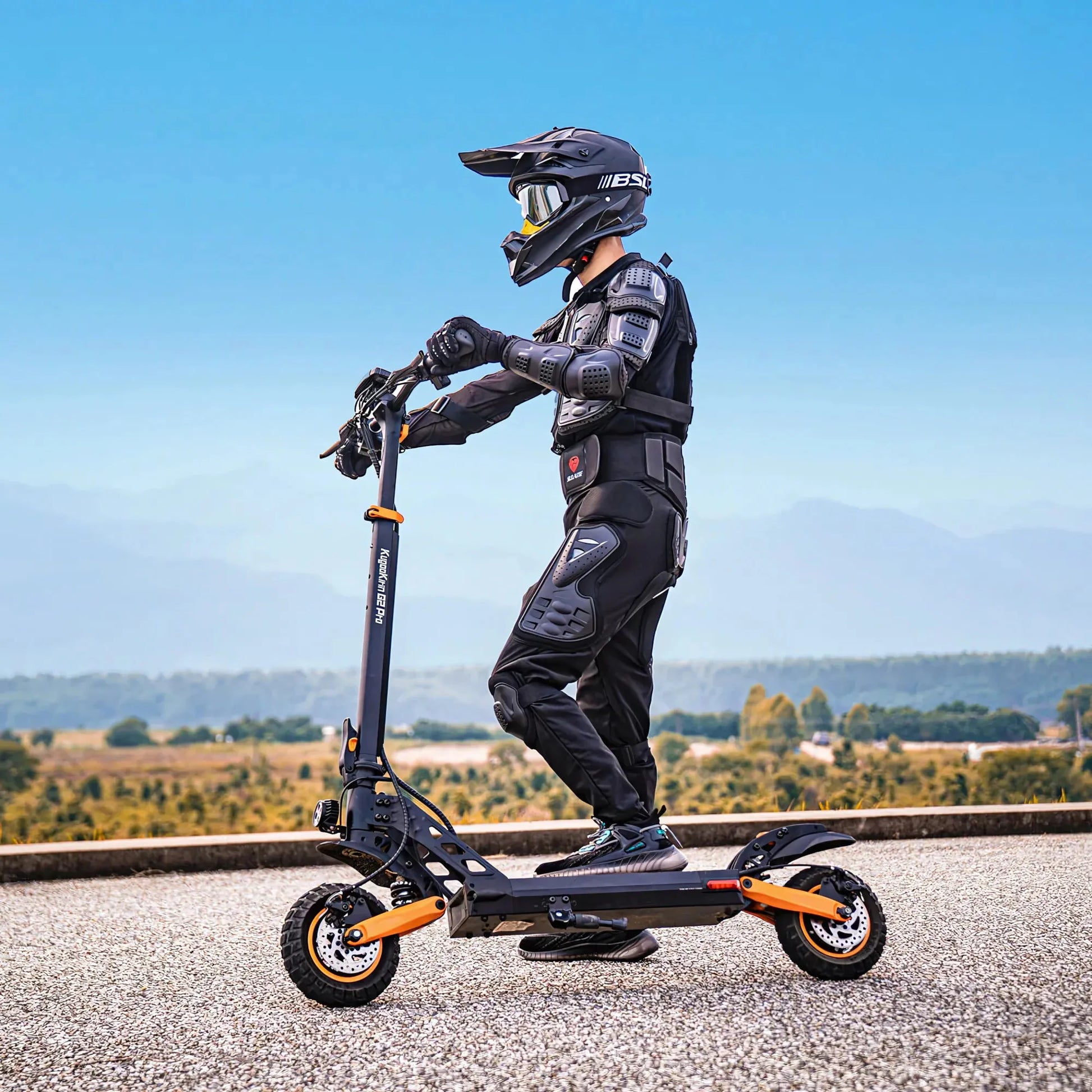 Electric Scooter Kukirin G2 Pro, sleek design, sturdy build, rider in protective gear, perfect for off-road adventures.