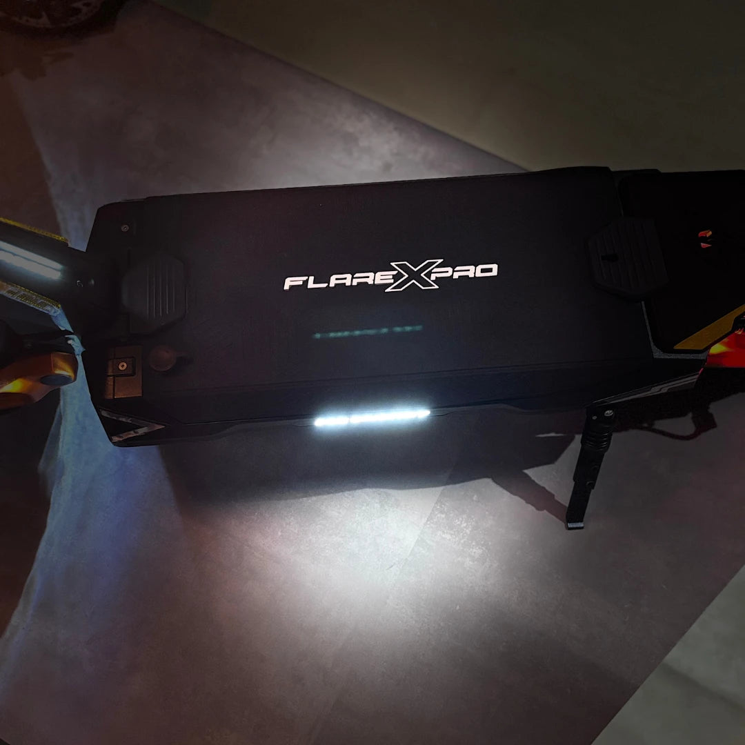 Electric Scooter Ms Energy Flare X Pro features a sleek black design with illuminated branding, ideal for night rides.