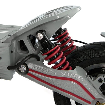 Izdelek je električni skiro, model Eco Speed 10X V2. Na sliki so vidni del podvozja skiroja, ki vključuje vzmetenje z rdečimi vzmetmi, kar nakazuje na boljšo stabilnost in udobje med vožnjo. Vidna je tudi struktura kolesa in del okvirja, kar kaže na robustno zasnovo.