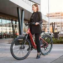 Electric Bike Econo Apes Eer4, stylish red electric bike, woman in black attire, urban setting, modern design.