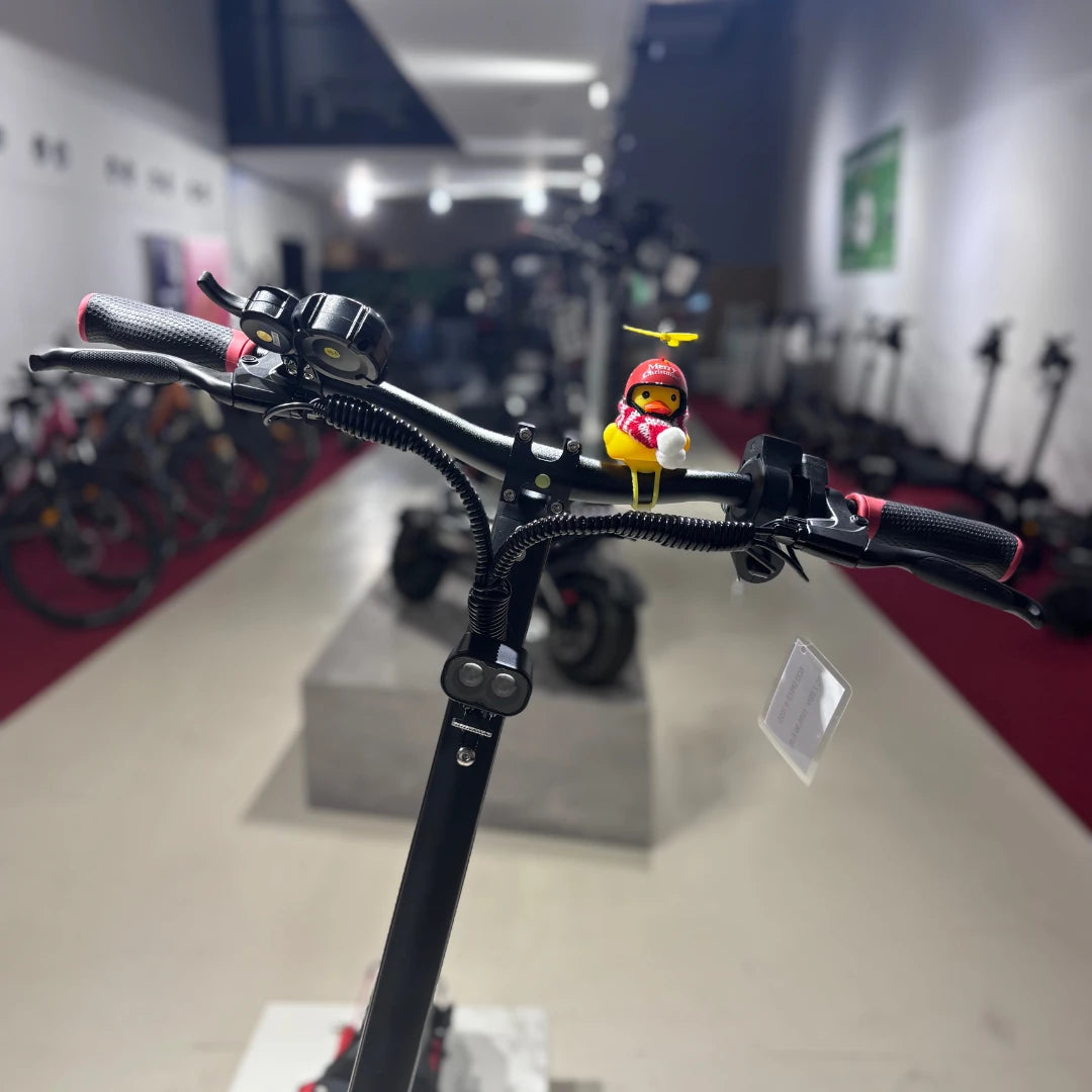 Electric Scooter Eco Speed 9 features a sleek design with comfortable grips and a fun toy on the handlebars.