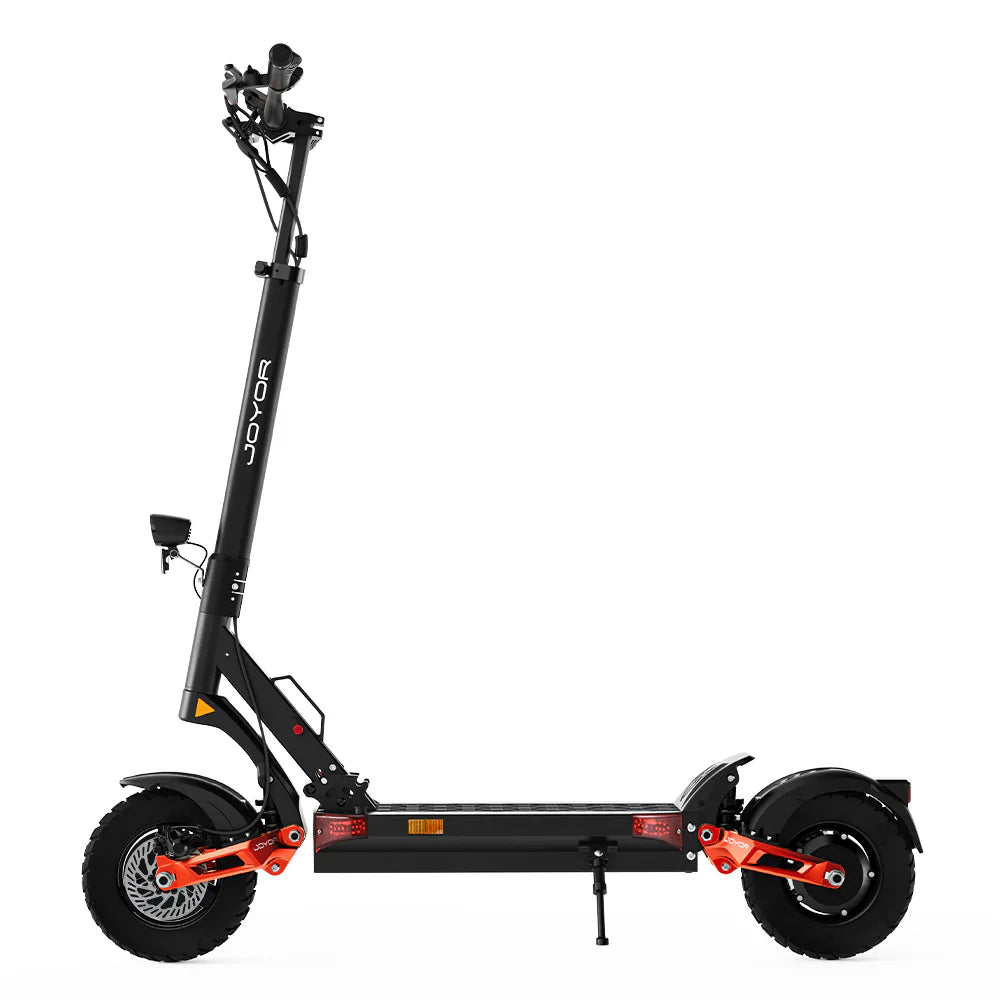 The product is the Joyor T10 electric scooter. The image shows a side view of the scooter, which has a black and orange color combination. Visible are its wide wheels, robust construction, and ergonomic handlebars. The scooter also features lighting elements and a folding mechanism.