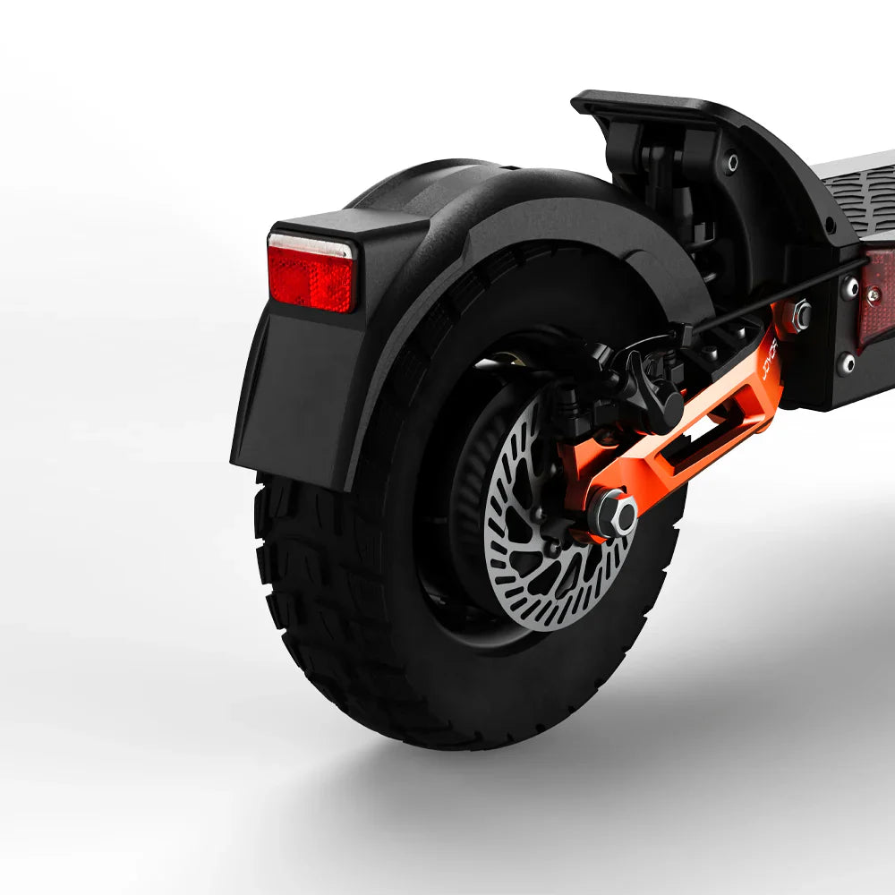 The product in the picture is a Joyor electric scooter, model T10. The picture shows the rear of the scooter, which includes a wide wheel with a rugged tread and a disc brake equipped with a color-accented caliper. The tail light is also visible, indicating the scooter's safety features.