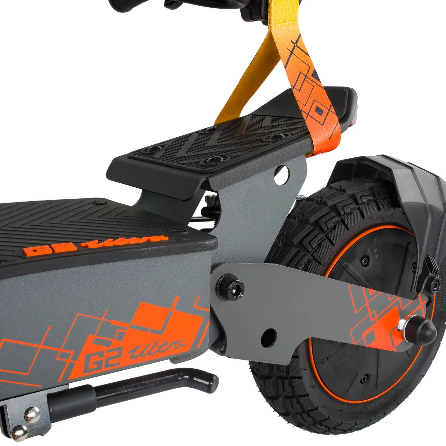 The picture shows a Kukirin G2 Ultra electric scooter. A detail of the rear section is visible, featuring the rubber wheels with tread for better grip and a part of the foot deck, which has a textured surface for increased safety. It is also equipped with a carrying loop. The color combination includes grey with orange details.