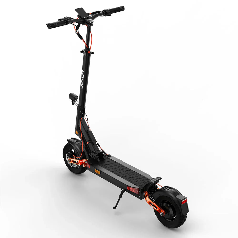 The product in the picture is a Joyor T6 electric scooter. The scooter is shown in black with orange details. It has a wide deck, a high handlebar, and large front and rear tires, which allows for a comfortable ride. The handlebar is equipped with grips for a better hold.