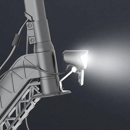 Izdelek na sliki je električni skiro, model Joyor S5 Z. Na sliki je prikazana sprednja luč skiroja, ki oddaja svetlobo, ter del konstrukcije, ki vključuje okvir in povezovalne elemente. Luč je zasnovana za izboljšanje vidljivosti med vožnjo v temnejših razmerah.