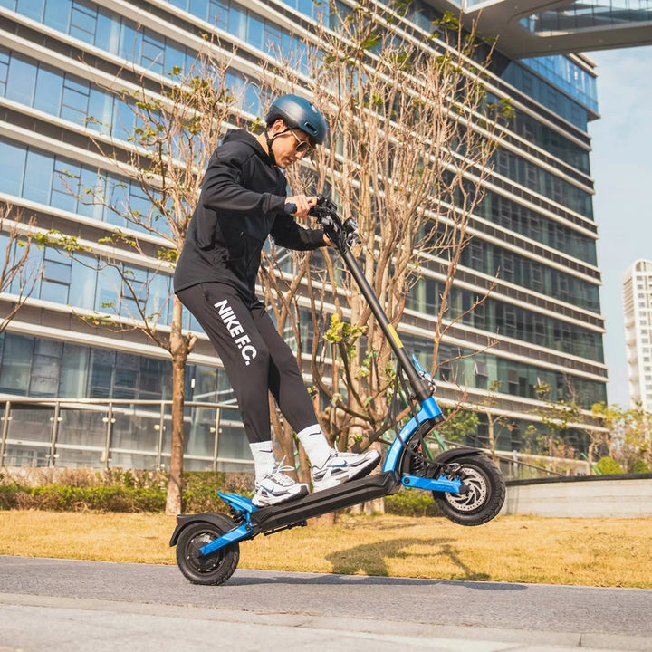 Oseba izvede skok z električnim skirojem Kaabo Mantis X Plus v urbanem okolju.