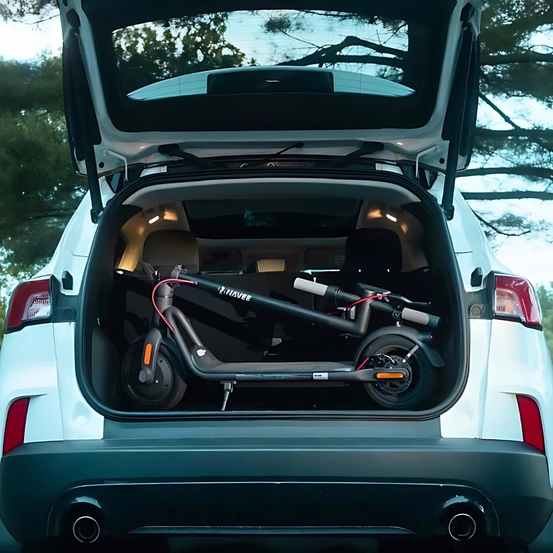 Electric Scooter Navee V50i Pro, compact and folded, showcased in the trunk of a car, ready for travel.