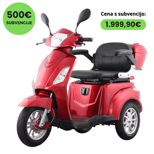 Izdelek je trikolesni električni mobilni skuter, znamke Vigorous, model Vista 1. Na sliki je vidna rdeča barva skuterja, ki ima udoben sedež in prostor za shranjevanje na zadnjem delu. Opremljen je z ogledali in lučmi, kar nakazuje na njegovo uporabnost v urbanem okolju. V zgornjem delu slike je navedena cena s subvencijo.