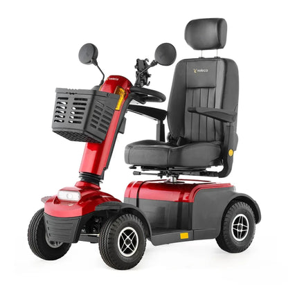 Izdelek je električni skuter, znamke Veleco, model Looper. Na sliki je prikazan skuter v rdeči barvi, opremljen s širokim sedežem in naslonjalom za glavo. Ima tudi ročaje, ogledala in sprednji koš za shranjevanje. Kolesa so široka, kar omogoča stabilno vožnjo.