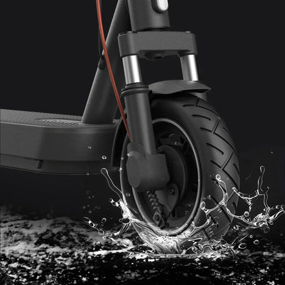 Izdelek na sliki je električni skiro, znamke Xiaomi, model 5 Pro. Na sliki je prikazana sprednja kolesa skiroja, ki se pelje po vodi, kar poudarja njegovo vodoodpornost in zmogljivost na različnih površinah. Vidna je tudi robustna konstrukcija in detajli na kolesu, kar kaže na kakovost izdelave.