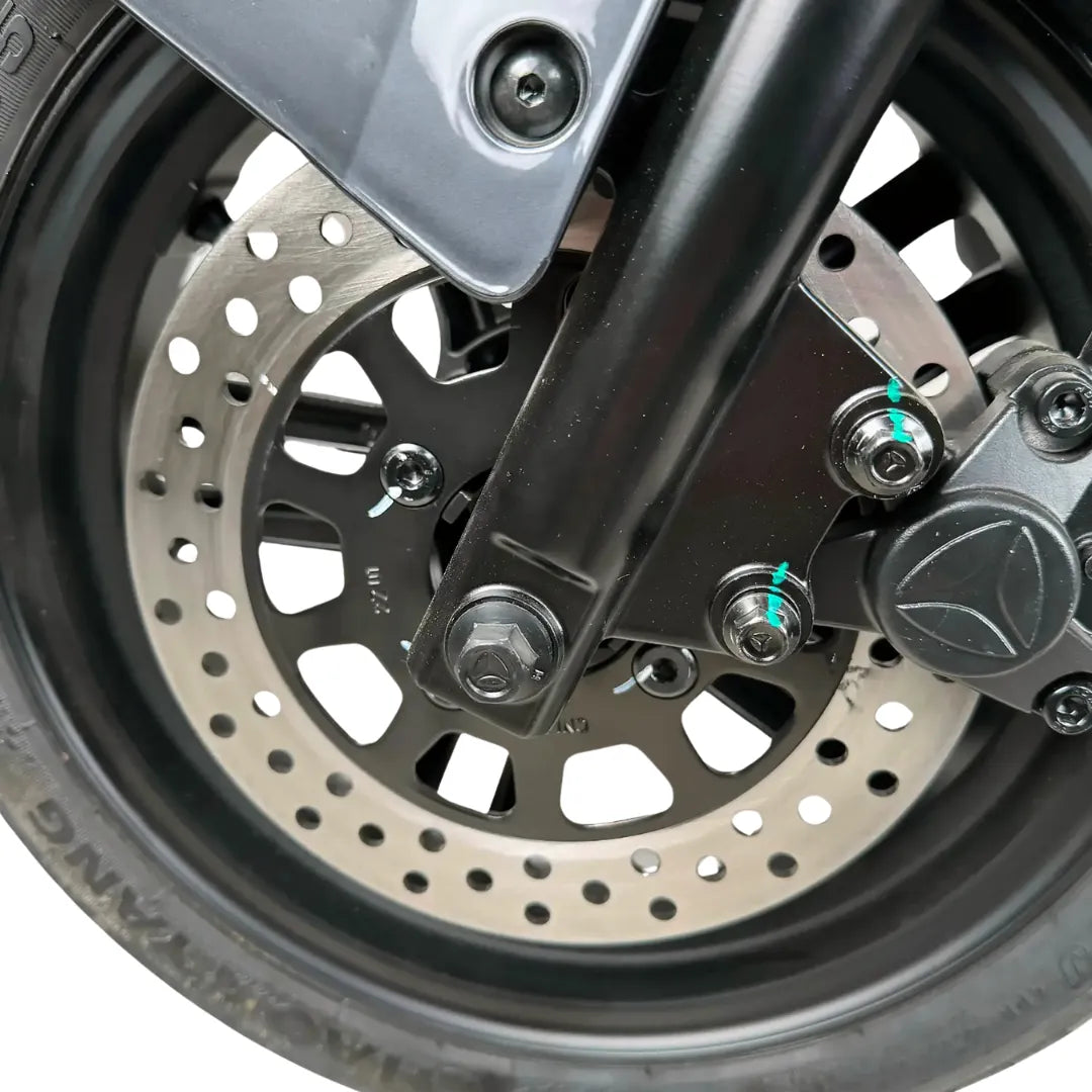 Od blizu posnet zavorni disk in kolo električnega skuterja Yadea Ezeego.